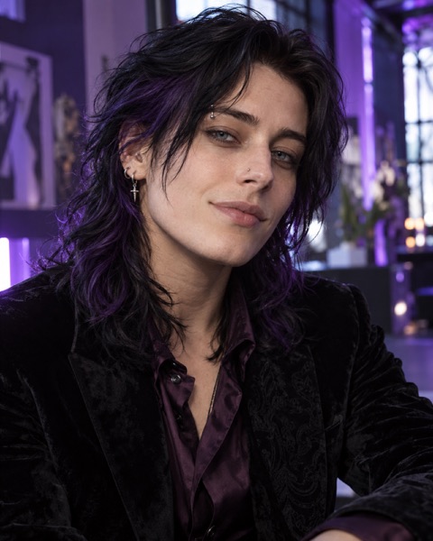 Eli, an Irish trans man with violet-black hair and modern gothic style